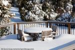 Snowy modern deck with wooden table